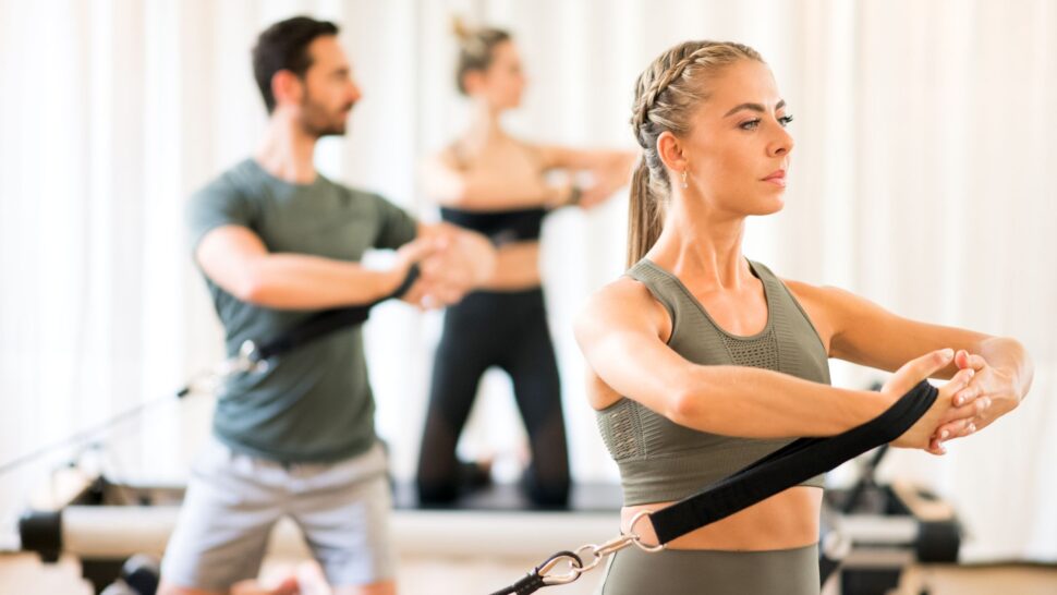Instructor guiding small group Reformer Pilates class in Cork across different levels