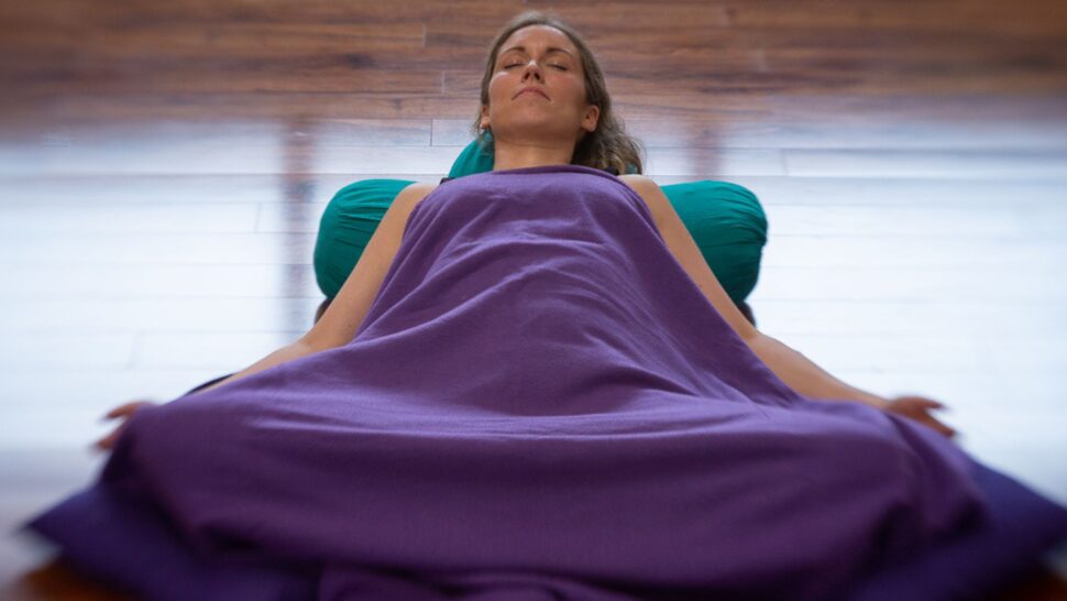 Students in a Yin Yoga class in Cork using props for relaxation