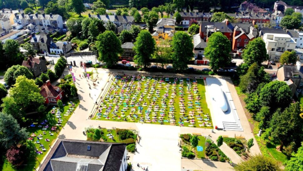 Group of yoga participants smiling at Yoga in the Park Cork 2025